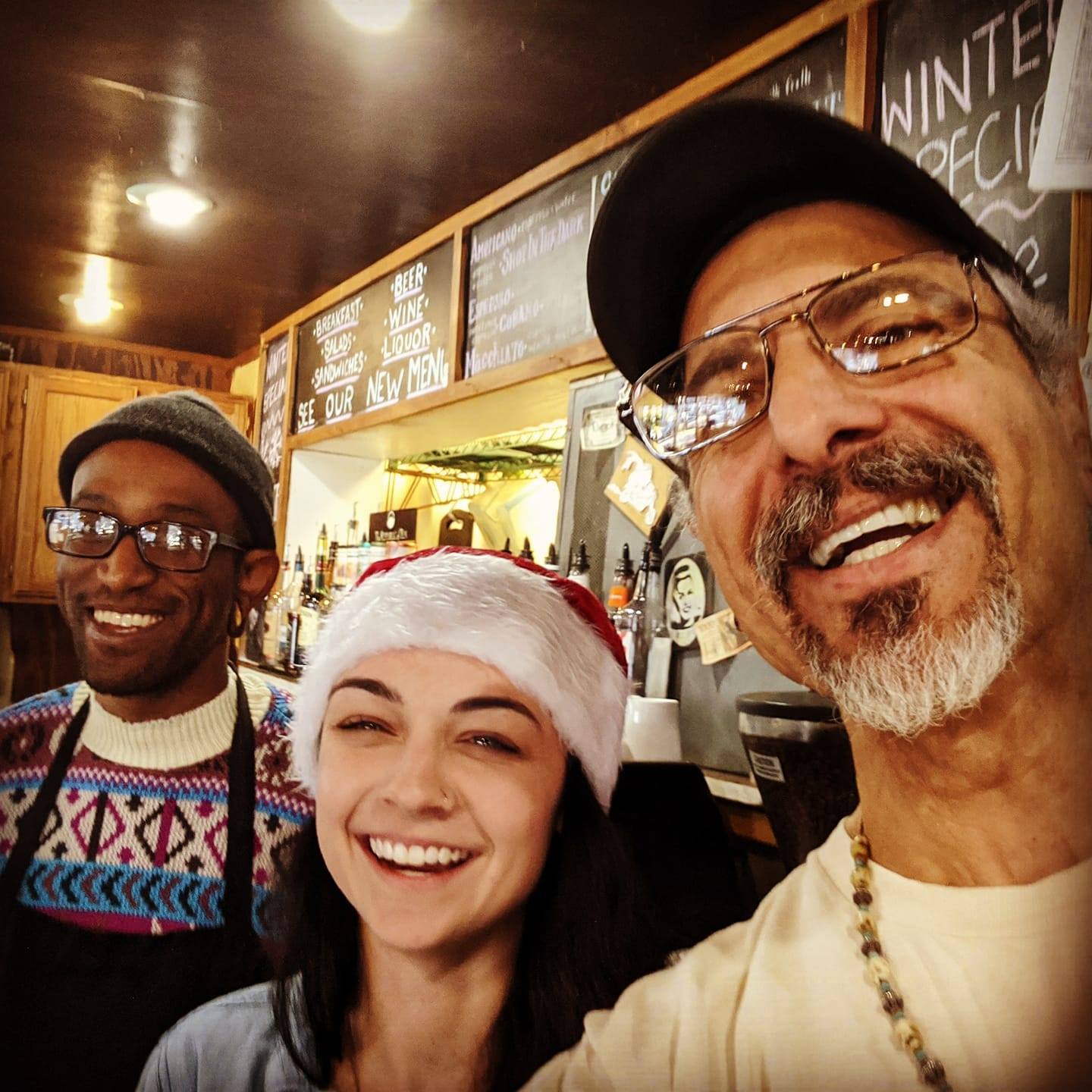 Johnny Gianoulidis (right) behind the counter at Parkgrounds with members of the team.